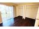 Bright bedroom features dark wood floors, a large window, and ample closet space at 7113 E Bank Dr # 7113, Tampa, FL 33617