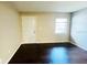 Living room showing hardwood floors, with a good view of the front door and window at 7113 E Bank Dr # 7113, Tampa, FL 33617