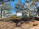 Community playground with swings and a slide set amongst beautiful mature oak trees and dappled sunshine at 7113 E Bank Dr # 7113, Tampa, FL 33617