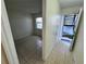 Bedroom showcases tile flooring, a window, and convenient access to the hallway at 7177 E Bank Dr # 102, Tampa, FL 33617