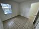 Cozy bedroom with tile flooring, natural light from a window, and closet at 7177 E Bank Dr # 102, Tampa, FL 33617