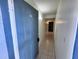 Hallway view featuring tile flooring and neutral paint, leading to other rooms at 7177 E Bank Dr # 102, Tampa, FL 33617