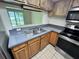 Close up of kitchen featuring stainless steel appliances, tiled floors, and a window at 7177 E Bank Dr # 102, Tampa, FL 33617