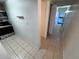 View of kitchen and hallway, featuring tiled floors and neutral wall color at 7177 E Bank Dr # 102, Tampa, FL 33617