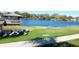 Peaceful lake view featuring a wooden deck and a flock of ibis on the grassy shore at 7177 E Bank Dr # 102, Tampa, FL 33617