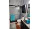 Bathroom featuring a glass-enclosed shower, vessel sink on a granite countertop, and a dark wood vanity at 10327 Meadow Crossing Dr, Tampa, FL 33647