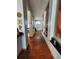 Long hallway featuring tile floors, arched windows, and decorative wall art at 10327 Meadow Crossing Dr, Tampa, FL 33647