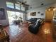 Spacious living room with tile floors, a ceiling fan, and sliding glass doors to the pool at 10327 Meadow Crossing Dr, Tampa, FL 33647