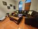 Comfortable living room featuring terracotta tile flooring, arched windows, and modern decor at 10327 Meadow Crossing Dr, Tampa, FL 33647