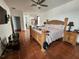 Spacious main bedroom with a large wooden bed, terracotta tile, and neutral décor at 10327 Meadow Crossing Dr, Tampa, FL 33647