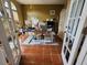 Well-lit home office with a large desk, white french doors, and terracotta tile flooring at 10327 Meadow Crossing Dr, Tampa, FL 33647