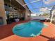 Inviting screened-in pool with a spacious deck, perfect for outdoor relaxation and entertainment at 10327 Meadow Crossing Dr, Tampa, FL 33647