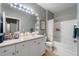 Bright bathroom with a vanity, mirror with lighting, and a shower-tub combination at 4221 W Spruce St # 2108, Tampa, FL 33607