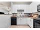 Functional kitchen featuring white cabinetry, stainless steel sink, and an integrated dishwasher at 4221 W Spruce St # 2108, Tampa, FL 33607