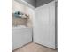 Functional laundry room with a washer, dryer, and shelving for storage at 4221 W Spruce St # 2108, Tampa, FL 33607