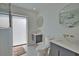 Modern bathroom featuring floating vanities, round mirrors, and a glass-enclosed shower at 4760 Meredith Ln, Sarasota, FL 34241