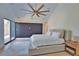 Bright bedroom with a high ceiling, modern fan and a black accent wall at 4760 Meredith Ln, Sarasota, FL 34241