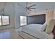 Bedroom featuring a large fan, hardwood floors, and sliding glass doors at 4760 Meredith Ln, Sarasota, FL 34241