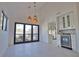 Bright dining space featuring modern pendant lighting and views of the outdoor pool at 4760 Meredith Ln, Sarasota, FL 34241