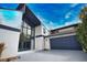 Striking home featuring a two-car garage and modern architectural design elements including a wall of windows at 4760 Meredith Ln, Sarasota, FL 34241