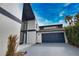 Stylish two-story home showcasing a unique window design and a two-car garage at 4760 Meredith Ln, Sarasota, FL 34241