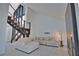 Contemporary living room with a staircase, high ceilings, and comfortable sectional sofa at 4760 Meredith Ln, Sarasota, FL 34241