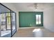 Living room featuring hardwood floors, a ceiling fan, and sliding glass doors to the outside at 4760 Meredith Ln, Sarasota, FL 34241