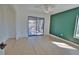 Living room featuring hardwood floors, a ceiling fan, and sliding glass doors to the outside at 4760 Meredith Ln, Sarasota, FL 34241