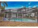 Poolside view of backyard showcasing the screened-in pool and modern architecture at 4760 Meredith Ln, Sarasota, FL 34241