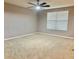 Bedroom with neutral carpet, ceiling fan, and window at 8283 47Th Street E Cir, Palmetto, FL 34221