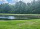 Pond surrounded by grassy area and lush trees at 8283 47Th Street E Cir, Palmetto, FL 34221