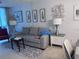 Cozy living area with neutral decor, a comfortable sofa, and decorative wall art at 12300 Vonn Rd # 7203, Largo, FL 33774