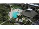 Aerial shot of community pool and clubhouse with palm trees and lush tropical landscaping at 12300 Vonn Rd # 7203, Largo, FL 33774