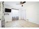 Bright and airy bedroom featuring neutral walls, tiled floors, and a ceiling fan at 1321 Groveland Ave, Venice, FL 34285