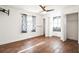 Bedroom boasts wood floors, a ceiling fan, and natural light from the surrounding windows at 1321 Groveland Ave, Venice, FL 34285