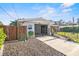 A driveway leading to a carport with black iron gates, adjacent to the house at 1321 Groveland Ave, Venice, FL 34285