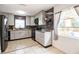 Updated kitchen featuring gray cabinets, stainless steel appliances and neutral countertops at 1321 Groveland Ave, Venice, FL 34285