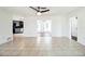 Spacious living area featuring tiled floors, white walls, and view of the kitchen at 1321 Groveland Ave, Venice, FL 34285