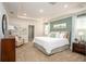 This main bedroom features recessed lighting, a tray ceiling, and neutral decor at 25172 Calusa Dr, Punta Gorda, FL 33955