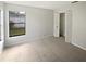 Bright bedroom with neutral carpet, a closet, and a window overlooking the backyard at 3402 Rankin Dr, New Port Richey, FL 34655