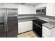 A modern kitchen featuring stainless steel appliances, sleek countertops and white cabinets at 3402 Rankin Dr, New Port Richey, FL 34655