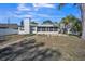 Large backyard featuring a screened in porch with mature trees for added privacy at 7840 Gulf Way, Hudson, FL 34667