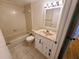 Bathroom features a single sink vanity, toilet, and a shower-tub combo with neutral tiling at 4034 Dream Oak Pl # 104, Tampa, FL 33613
