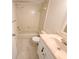 Neutral-colored bathroom with tiled shower-tub and white vanity with marble-look countertop at 4034 Dream Oak Pl # 104, Tampa, FL 33613