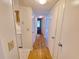 Hallway with plank floors that leads to the kitchen and bedrooms with neutral color scheme at 4034 Dream Oak Pl # 104, Tampa, FL 33613