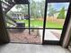Cozy screened patio with a view of the lush green lawn, offering a serene outdoor space for relaxation at 4034 Dream Oak Pl # 104, Tampa, FL 33613
