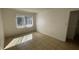 Bright bedroom space featuring neutral color palette, tiled floors, and a window at 7502 Needle Leaf Pl # B66, Tampa, FL 33617