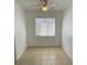 Bright bedroom with ceiling fan, white walls, tile floor, and window at 7502 Needle Leaf Pl # B66, Tampa, FL 33617