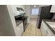 Updated kitchen featuring stainless steel appliances, granite counters, and white cabinets at 7502 Needle Leaf Pl # B66, Tampa, FL 33617