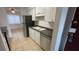 Kitchen featuring stainless steel appliances, white cabinets, and tile flooring at 7502 Needle Leaf Pl # B66, Tampa, FL 33617